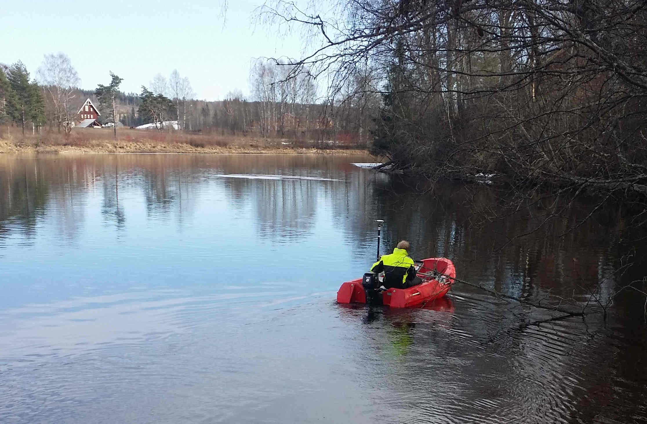 staff member mapping a lake bed on a boat